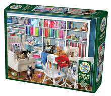 Load image into Gallery viewer, A 1000-piece Cobble Hill puzzle depicting a colorful sewing room scene with various sewing accessories and six cats.